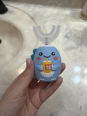 Blue BrushBuddy handle held in a parent's hand by the bathroom sink