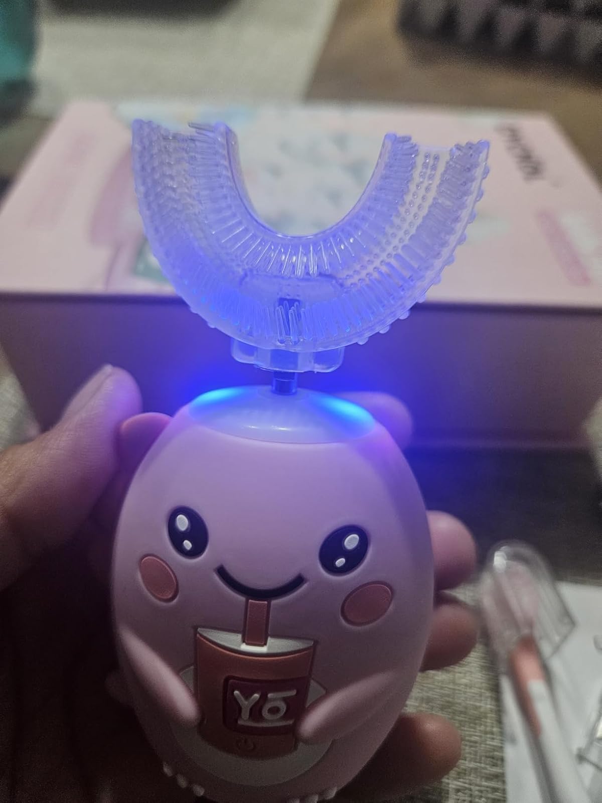 BrushBuddy head lit by the blue sanitizing light